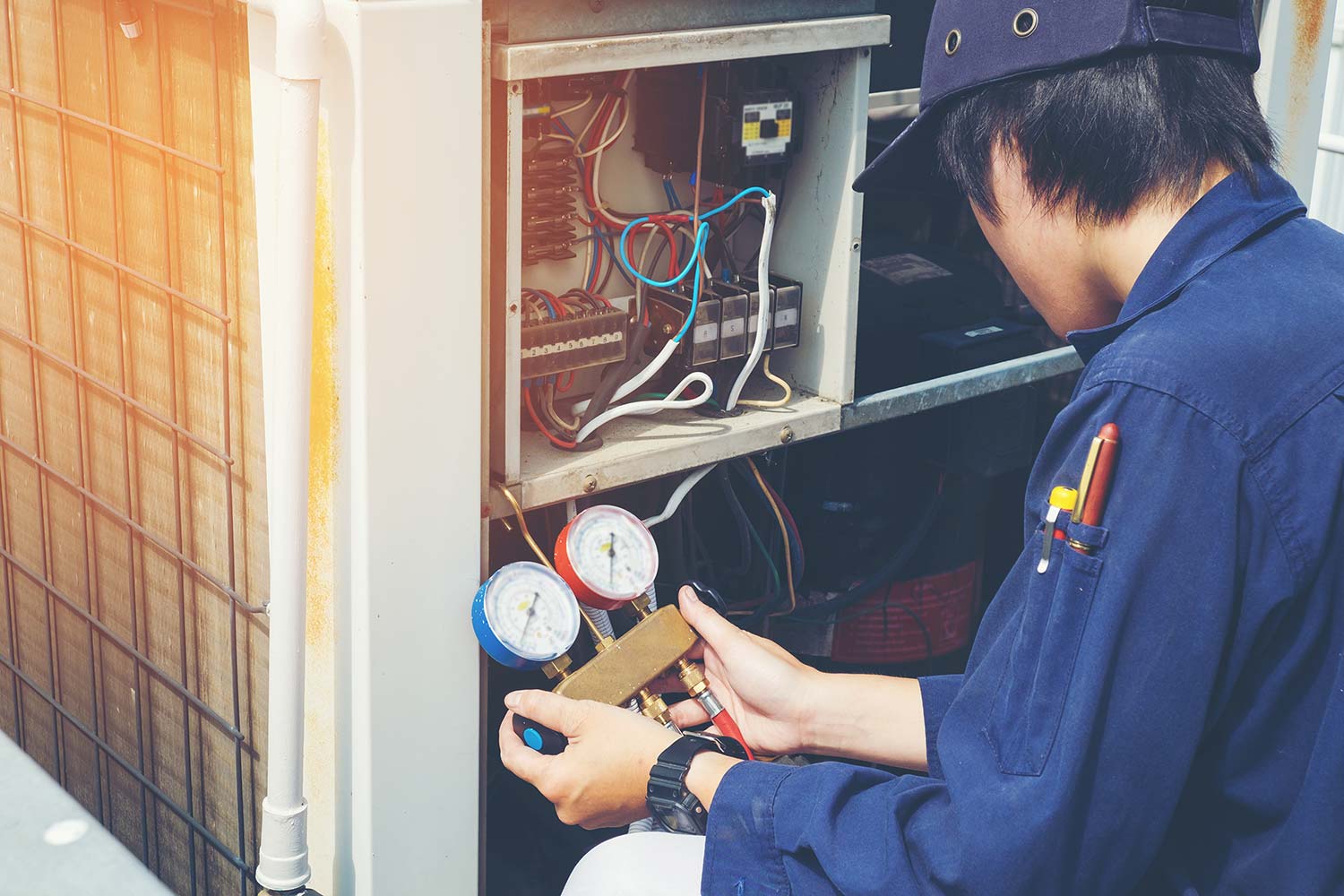 HVAC technician inspecting a Lennox air conditioner unit